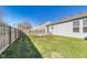 Spacious backyard with a lush green lawn and a wood fence, providing a private and secure outdoor space at 1850 Blue Pine Ln, Indianapolis, IN 46231