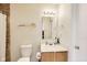 Bright bathroom featuring a white sink vanity, a toilet, towel rack and mirror at 1850 Blue Pine Ln, Indianapolis, IN 46231