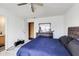 Bright bedroom showcasing a bed, a ceiling fan, black furnishings, and a mirrored dresser at 1850 Blue Pine Ln, Indianapolis, IN 46231