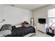 Bright bedroom with bed, dresser, and natural light streaming through the windows at 1850 Blue Pine Ln, Indianapolis, IN 46231