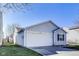 Home exterior showing a two car garage and well manicured lawn at 1850 Blue Pine Ln, Indianapolis, IN 46231