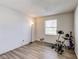 Bright room featuring laminated floors and exercise equipment at 1850 Blue Pine Ln, Indianapolis, IN 46231