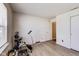 Bright room featuring laminated floors and exercise equipment at 1850 Blue Pine Ln, Indianapolis, IN 46231