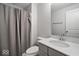 Clean bathroom featuring a shower with gray curtain and a stylish vanity at 19036 Karyn Ln, Noblesville, IN 46062