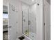 Modern bathroom featuring a glass shower enclosure and white marble-style tile at 19036 Karyn Ln, Noblesville, IN 46062