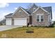 Beautifully designed two-story brick home with a three car garage and a well maintained lawn at 19036 Karyn Ln, Noblesville, IN 46062