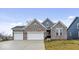 Attractive brick home with three-car garage and well-manicured lawn at 19036 Karyn Ln, Noblesville, IN 46062