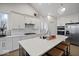 Bright kitchen with white cabinets, stainless steel appliances, island with bar seating, and modern finishes at 19036 Karyn Ln, Noblesville, IN 46062