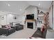 Stylish living room with a fireplace, comfortable seating, and elegant decor, ideal for relaxing and entertaining guests at 19036 Karyn Ln, Noblesville, IN 46062