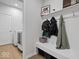 Convenient mud room with built-in bench, storage and laundry access at 19036 Karyn Ln, Noblesville, IN 46062