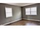 Bright bedroom featuring updated vinyl wood-look flooring, and neutral gray walls with white trim at 1904 S Rosemont Ave, Muncie, IN 47302
