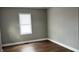Cozy bedroom featuring gray walls, wood-look flooring, white trim, and a window with white blinds at 1904 S Rosemont Ave, Muncie, IN 47302