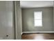 Neutral bedroom with wood-look floors, light walls, and a window at 1904 S Rosemont Ave, Muncie, IN 47302