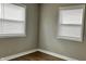 Sunlit bedroom with two windows, neutral walls, and modern laminate flooring at 1904 S Rosemont Ave, Muncie, IN 47302