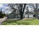 View of a single-story home with light green siding and an unkept front yard at 1904 S Rosemont Ave, Muncie, IN 47302