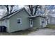 Charming single-story home with light green siding, white trim, and a small front porch entrance at 1904 S Rosemont Ave, Muncie, IN 47302