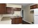 Traditional kitchen with wooden cabinets, laminate countertops, and a double basin stainless steel sink at 1904 S Rosemont Ave, Muncie, IN 47302