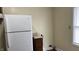 Corner of a kitchen featuring white appliances, a light wall, and wood-look flooring at 1904 S Rosemont Ave, Muncie, IN 47302