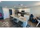 Bright kitchen with an island featuring bar stool seating and a view into the living area, great for entertaining at 19350 Goins Blvd, Westfield, IN 46074