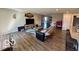 Open-concept living area with modern furnishings and hardwood floors that seamlessly transition into the kitchen at 19350 Goins Blvd, Westfield, IN 46074