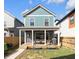 Backyard featuring a covered patio and green lawn, complemented by garden beds and a privacy fence at 1945 Carrollton Ave, Indianapolis, IN 46202