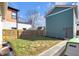 Backyard features a small patch of grass, fenced in area and a side path at 1945 Carrollton Ave, Indianapolis, IN 46202