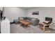 Finished basement boasts a comfortable gray sectional couch, sleek furniture, and a cozy atmosphere at 1945 Carrollton Ave, Indianapolis, IN 46202