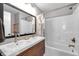 Modern bathroom featuring a double sink vanity, bathtub, and shower at 1945 Carrollton Ave, Indianapolis, IN 46202