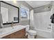 Bright bathroom with modern vanity, toilet and tub with shower at 1945 Carrollton Ave, Indianapolis, IN 46202