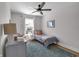 Cozy bedroom with twin bed, ceiling fan, patterned rug, and natural light from the window at 1945 Carrollton Ave, Indianapolis, IN 46202