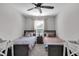 Bright bedroom featuring twin beds, a desk, and ample natural light at 1945 Carrollton Ave, Indianapolis, IN 46202