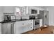 Well-lit kitchen featuring stainless steel appliances, white cabinets, and dark countertops, with a subway tile backsplash at 1945 Carrollton Ave, Indianapolis, IN 46202