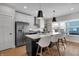 Modern kitchen with stainless steel appliances, a large island with bar seating, and sleek cabinetry at 1945 Carrollton Ave, Indianapolis, IN 46202