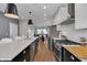 Contemporary kitchen showcasing an island with seating, modern appliances, and an open layout into the dining area at 1945 Carrollton Ave, Indianapolis, IN 46202