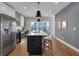 Modern kitchen with stainless steel appliances, a large island with bar seating, and sleek cabinetry at 1945 Carrollton Ave, Indianapolis, IN 46202
