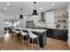 Modern kitchen with an island, stainless steel appliances, pendant lighting, and seating for four at 1945 Carrollton Ave, Indianapolis, IN 46202