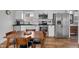 Charming kitchen with stainless appliances, white cabinets, and a dark countertop, adjacent to a wooden dining table at 1945 Carrollton Ave, Indianapolis, IN 46202