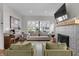 Bright living room with large windows, a cozy fireplace, and modern decor for comfortable living at 1945 Carrollton Ave, Indianapolis, IN 46202