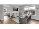 Cozy living room showcases hardwood floors, a comfortable sofa, and abundant natural light streaming through a large window at 1945 Carrollton Ave, Indianapolis, IN 46202