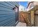 A small side yard area featuring a wooden gate and privacy fence, offering access to the property's exterior at 1945 Carrollton Ave, Indianapolis, IN 46202