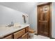 Bathroom features oak vanity with cream countertop, wood trim, and a wood door at 2054 Partridge Dr, Franklin, IN 46131