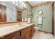 Bathroom featuring green walls, oak vanity, framed mirror, walk-in tub and towel rack at 2054 Partridge Dr, Franklin, IN 46131