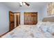 Comfortable bedroom with wood closet doors, seaside themed comforter, neutral walls and carpet at 2054 Partridge Dr, Franklin, IN 46131
