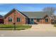 Charming single-story brick home with well-maintained lawn and long concrete driveway under clear blue skies at 2054 Partridge Dr, Franklin, IN 46131