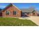 Attractive brick home with manicured front lawn and concrete driveway, perfect for curb appeal at 2054 Partridge Dr, Franklin, IN 46131