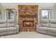 Close-up view of the brick fireplace with mantel and dual armchairs in a cozy living room at 2054 Partridge Dr, Franklin, IN 46131