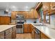 Functional kitchen featuring stainless steel appliances, oak cabinetry, and laminate countertops at 2054 Partridge Dr, Franklin, IN 46131