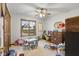 Spacious playroom with hardwood trim window, ceiling fan, carpeted floors, dresser and toys at 2054 Partridge Dr, Franklin, IN 46131