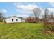 A spacious backyard view shows the home and detached garage at 209 Pennsylvania St, Shirley, IN 47384