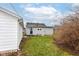 A spacious backyard view shows the home and detached garage at 209 Pennsylvania St, Shirley, IN 47384